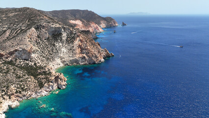 Aerial drone photo from tropical exotic paradise secluded rocky island bay with deep turquoise and sapphire sea forming a blue lagoon visited by yachts and sail boats in Caribbean exotic destination