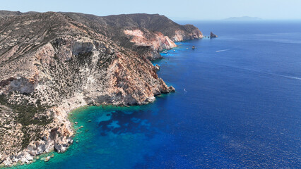 Aerial drone photo of paradise blue bay of uninhabited island of Polyaigos with turquoise crystal clear sea visited by luxury yachts and sail boats resembling a blue lagoon, Cyclades, Greece