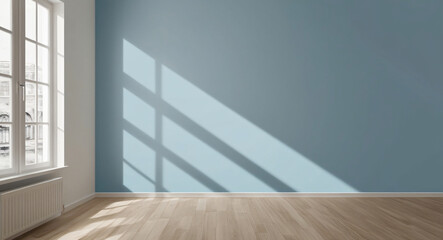 Sunlight casting geometric shadows in an empty blue room with large windows.