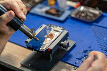Phone Back Glass Fix, Depicts a skilled technician replacing the back glass
