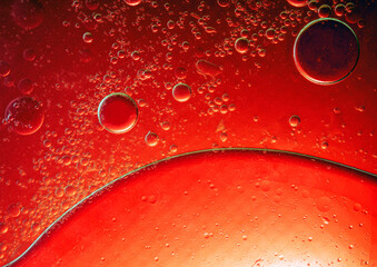 Abstract Background Red oil Macro Colorful artistic of oil drop floating on the water. macro red bubble oil of wallpeper, blood concept