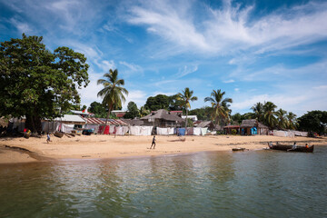 A tranquil village in Madagascar with sandy beaches and palm trees under a bright blue sky