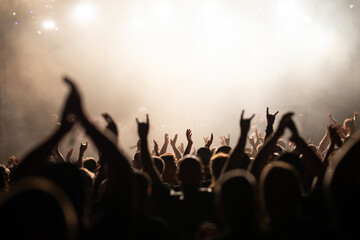Crowd at concert and colorful stage lights.