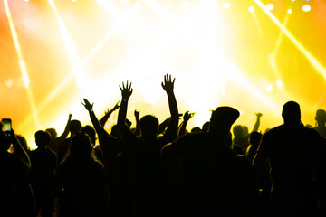 Crowd at concert and colorful stage lights.