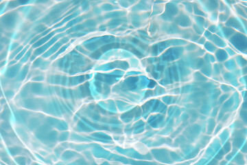 Blue water with ripples on the surface. Defocus blurred transparent blue colored clear calm water surface texture with splashes and bubbles. Water waves with shining pattern texture background.