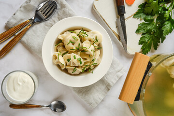 Close-up overhead view of dumplings in a plate on kitchen table