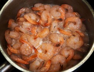 Shrimp boil in pan at home. Selective focus with shallow depth of field.