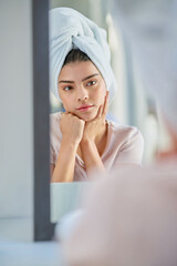 Mirror, thinking or woman in bathroom with beauty, glow or wellness in home for treatment. Towel, serious and girl with confidence, cosmetics results or skincare ideas with health or morning routine