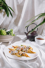 Savory stuffed crepes with mushrooms and creamy sauce on white plate