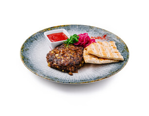 Juicy grilled cutlet served with pita bread and tomato sauce on plate