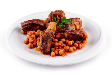 Delicious braised lamb shanks with chickpeas served on white plate