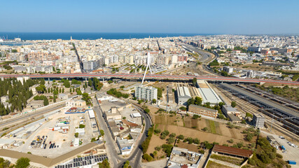 Aerial view of the Adriatic bridge in Bari, Puglia, Italy. It is a cable-stayed bridge that connects the city by passing over the railway. In the background is the Mediterranean Sea.