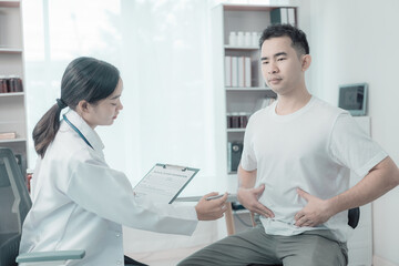 Obraz premium Asian female doctor and male patient discuss treatment with successful professional physician wearing white lab coat and stethoscope about injury