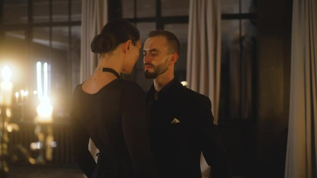 Couple showcasing passionate tango dance steps in a romantic setting.