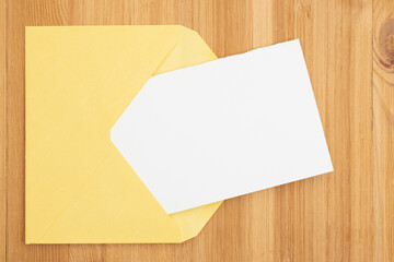 Blank greeting card with a envelop on wood