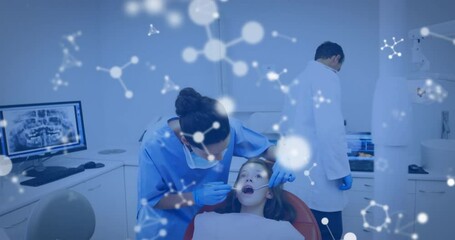 Animation of molecules over caucasian male and female dentists and girl patient - Powered by Adobe