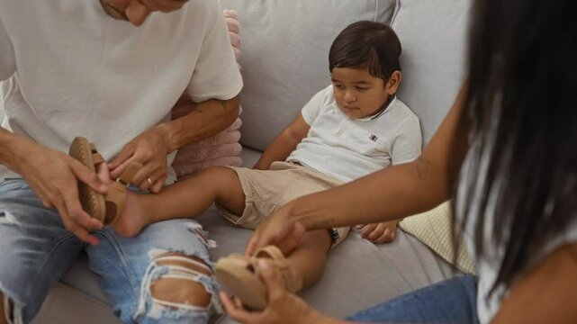 Family helping child put on sandals in cozy living room