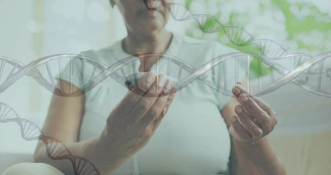 Animation of dna strands over senior african american woman using glucose meter