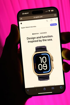 Paris, France - Sep 8, 2024: A male hand holding a smartphone with the Apple Store website open, showing the pre-order page for the Apple Watch Ultra 2 Herm s with the Design