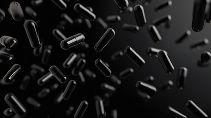 Black capsules spread out in the air on black background