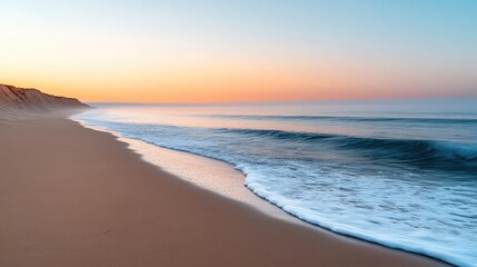 Obraz premium Summer sky with light mist hanging over a coastal landscape, soft waves breaking on the shore, the horizon blurred by the mist, peaceful and calming