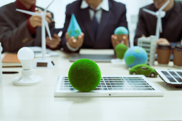 Three businessmen meet at a table to discuss the development of a clean energy and environmental city.Chongqing's transition to hydropower,wind power,solar power,biomass power geothermal power