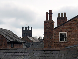 rooftop view of old british brick houses in chester with slate roofs and tall chimneys with the...