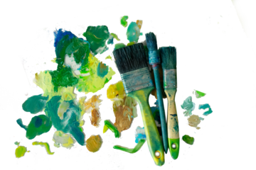 strokes of green paint on a palette, brushes for oil paints on a white background