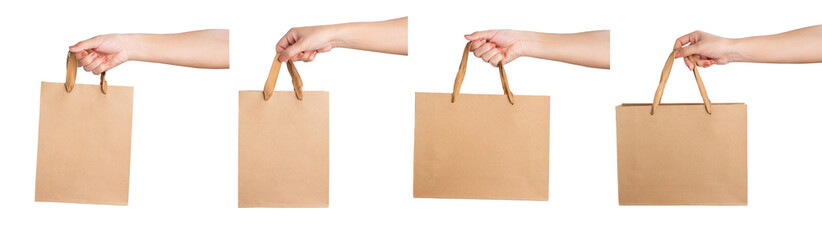 Hand holding brown paper bag on isolated on white background.