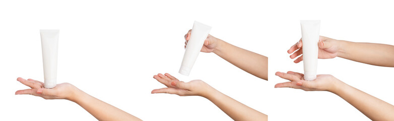 Female hand holding blank cosmetic bottle isolated on white background.