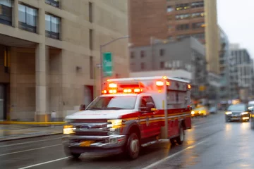 A blurred ambulance races through the bustling streets of New York City, a beacon of hope and help in times of need.