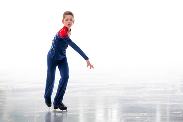 A boy ice skater in a Santa Claus hat is skating. © Maria Moroz