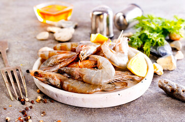 Uncooked Raw peeled tiger white shrimp prawn. Gray background.