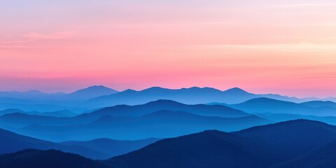 A breathtaking view of serene mountains at sunset, showcasing layers of blue and purple hues that inspire peace and tranquility.