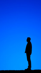 Silhouette of a Man Against a Blue Sky