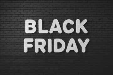 Obraz premium Black brick wall with the word black friday, sale and promotion concept.