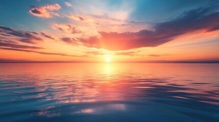 Fototapeta premium A breathtaking sunset over a calm ocean, with the sun dipping below the horizon and the sky