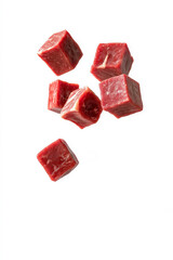 Diced beef cubes falling on white background