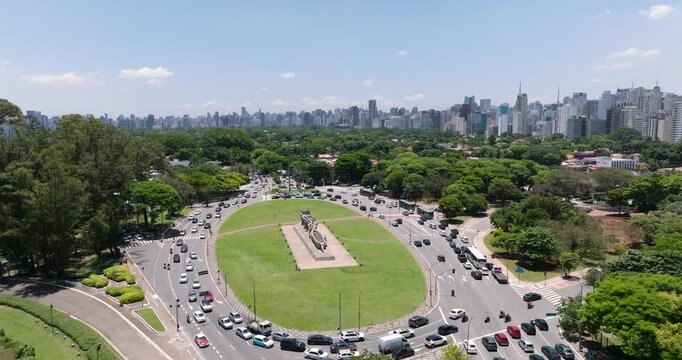 Aerial view of Ibirapuera Park surrounded by vibrant cityscape and bustling traffic, Sao Paulo, Brazil.