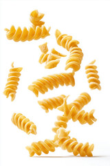 Naklejka premium Rotini pasta spirals falling on white background