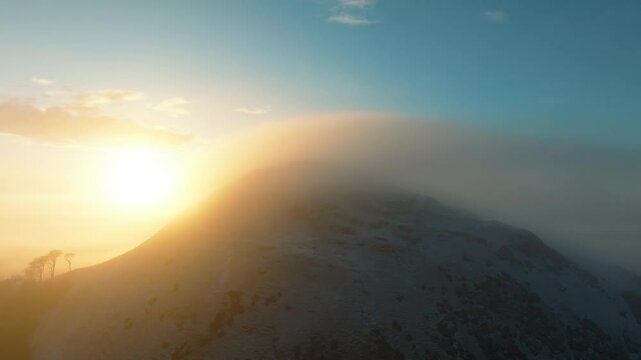 Aerial view of cloud inversion over North Berwick Law at sunrise, East Lothian, United Kingdom.