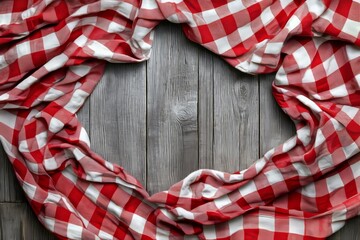 Fototapeta premium Picnic tablecloth with red checks on grey wooden table, top view.