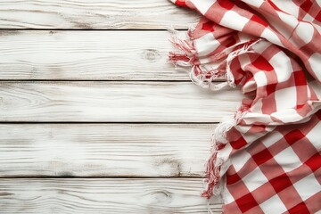 Fototapeta premium A red checkered picnic tablecloth is seen on top of a wooden table.