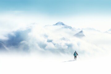 A lone skier navigates through snowy peaks beneath a clear blue sky during winter