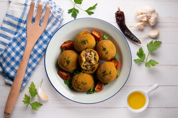 Spanish Tapa croquettes made with bechamel sauce and stuffed with octopus and potato. Top view table.