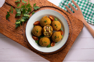 Spanish Tapa croquettes made with bechamel sauce and stuffed with octopus and potato. Top view table.