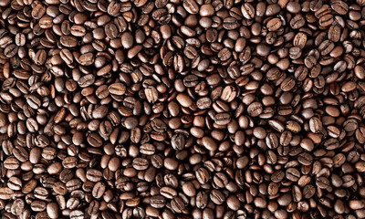 Top view background of aromatic brown coffee beans scattered on surface