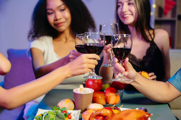 A diverse group of coworkers enjoying a casual office party or home with drinks, food,