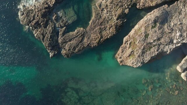 Aerial view of godrevy beach and cliffs with clear turquoise water, St Ives Bay, United Kingdom.