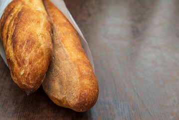 Two fresh french baguettes on a table in France